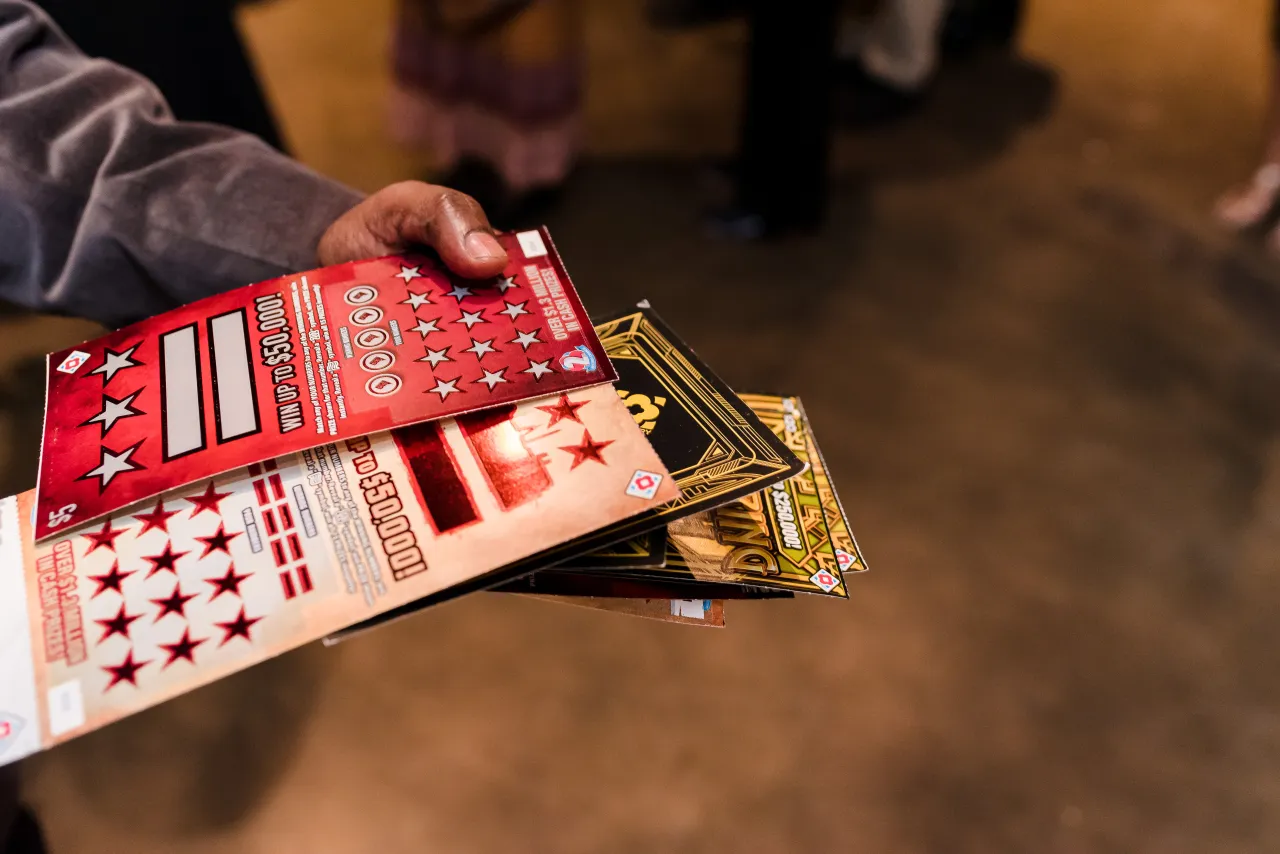 Man holding scratch tickets