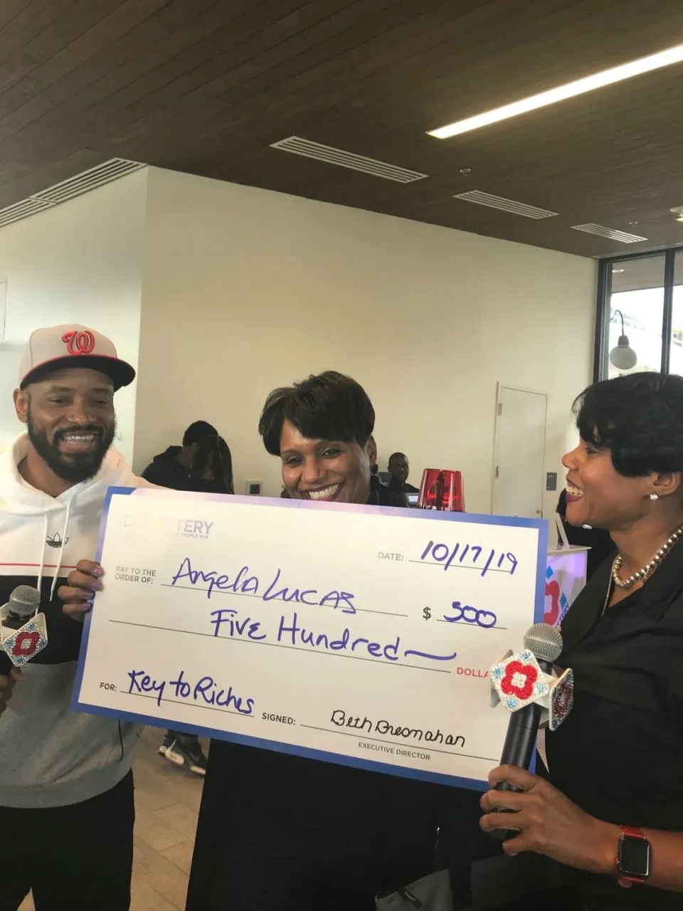 Player holding oversized check