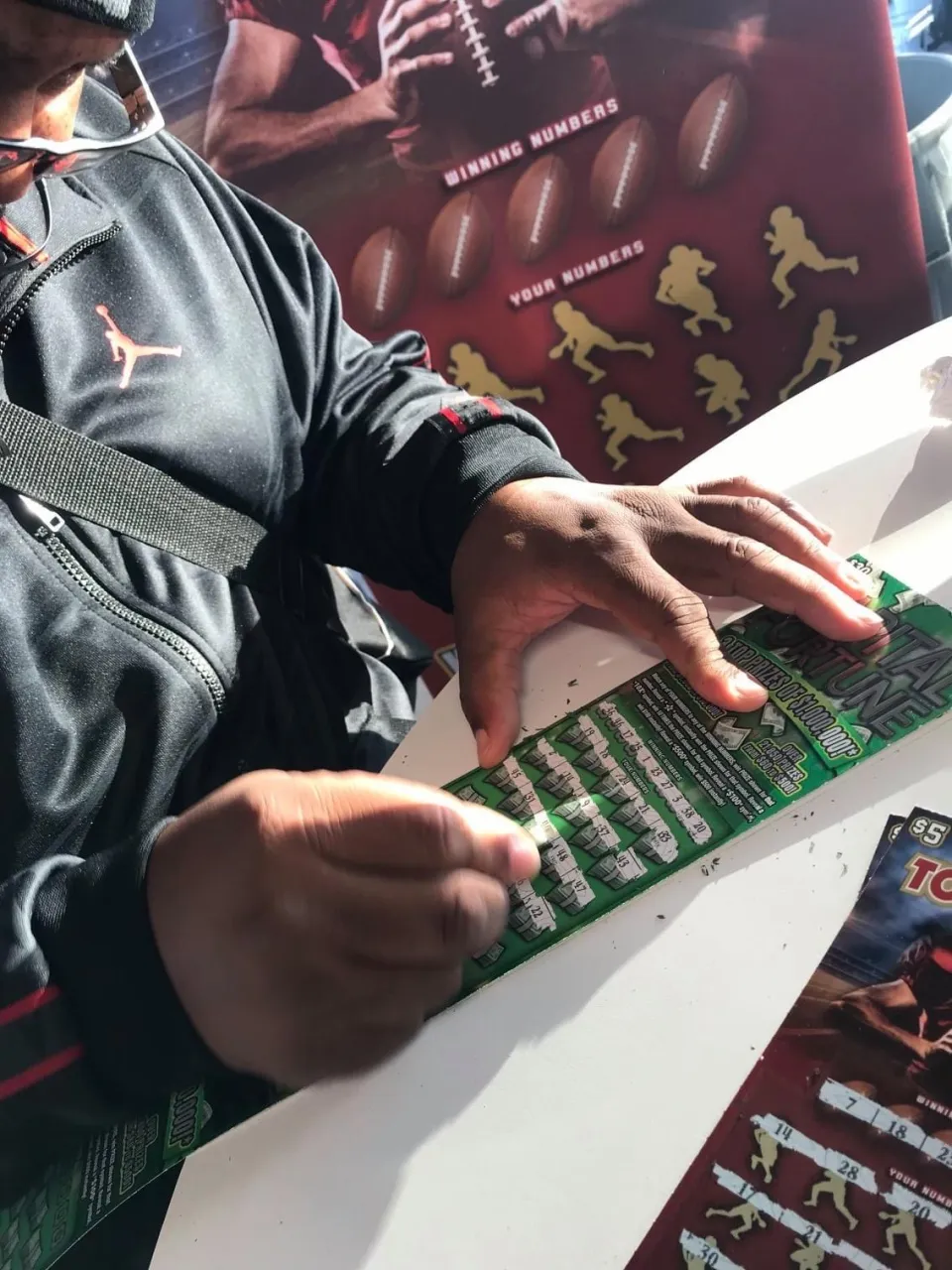 Player scratching tickets