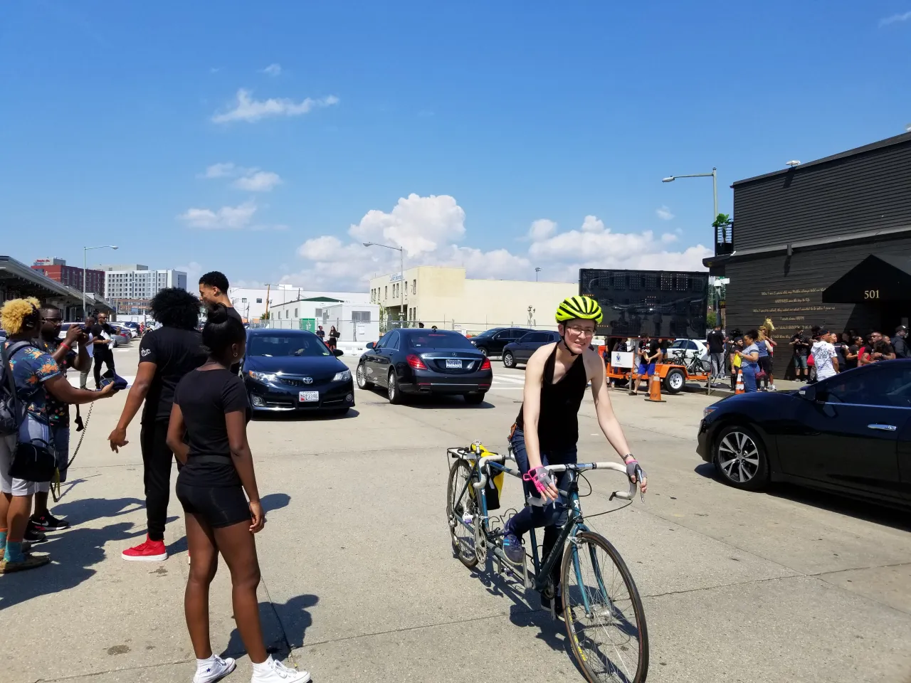 woman riding a bike through the crowd