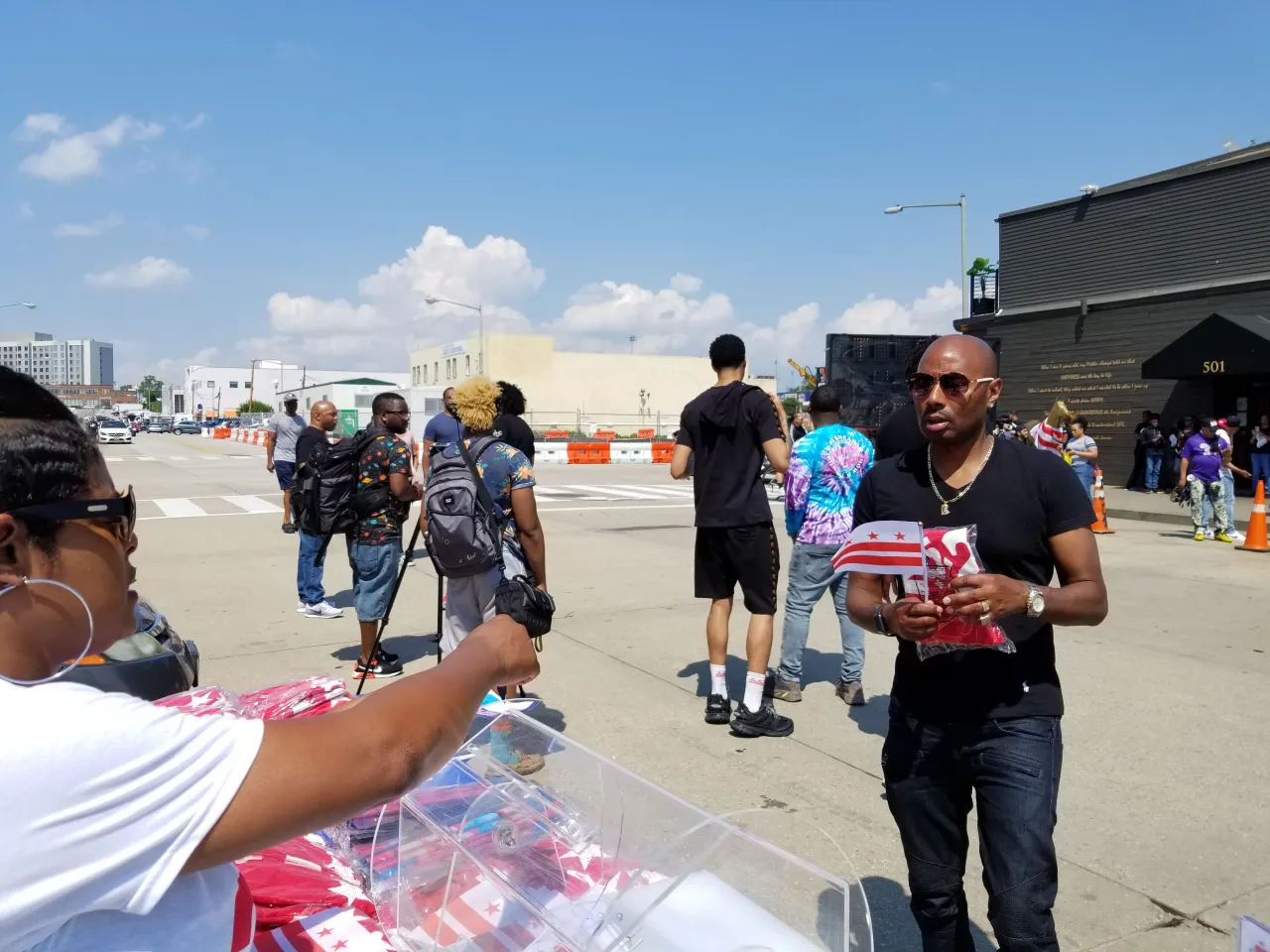 Man holding dc flag and 202 shirt