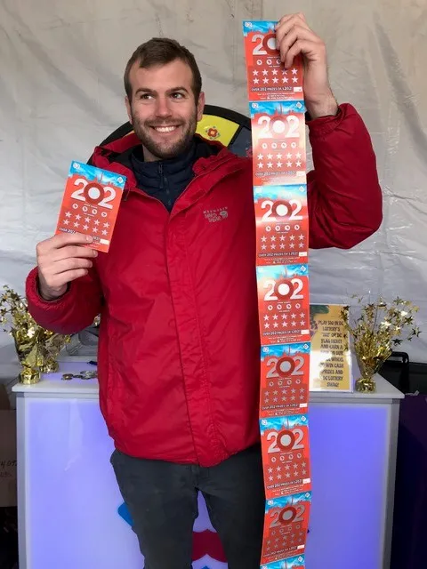 man holding scratch tickets