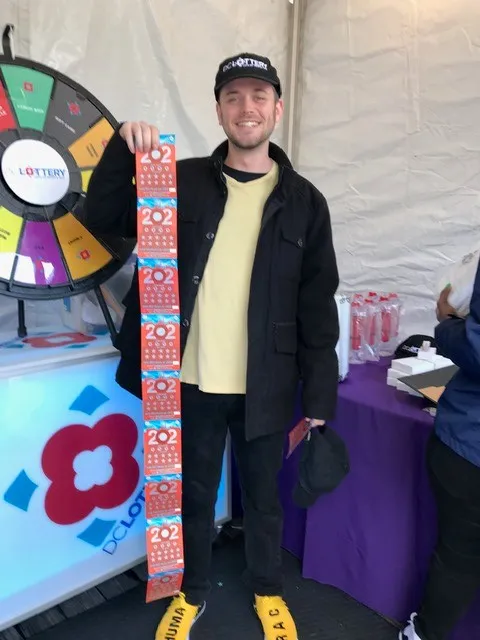 man holding scratch tickets