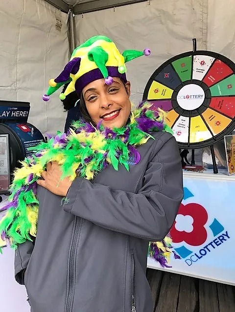 woman wearing jester hat and boa