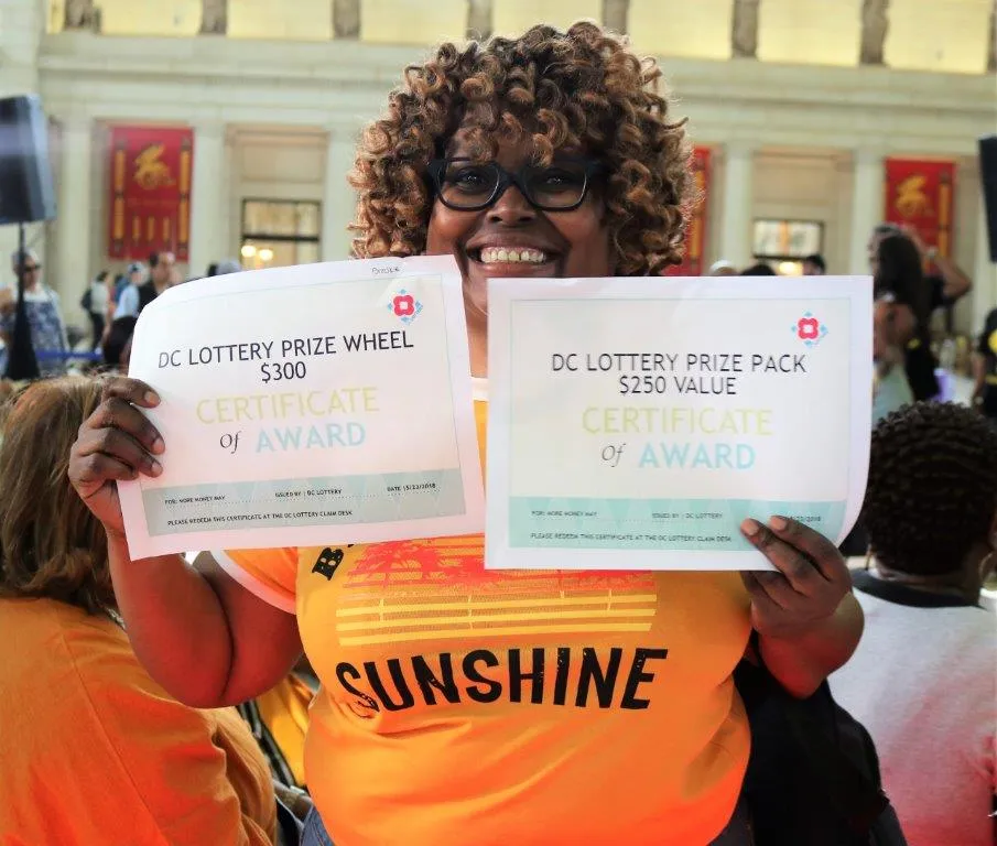 woman holding winner certificates