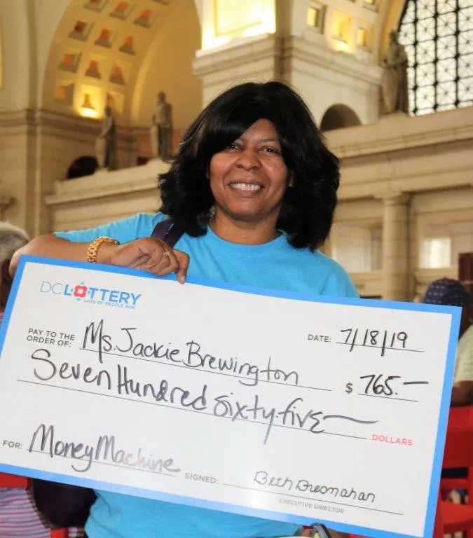 Woman holding large check