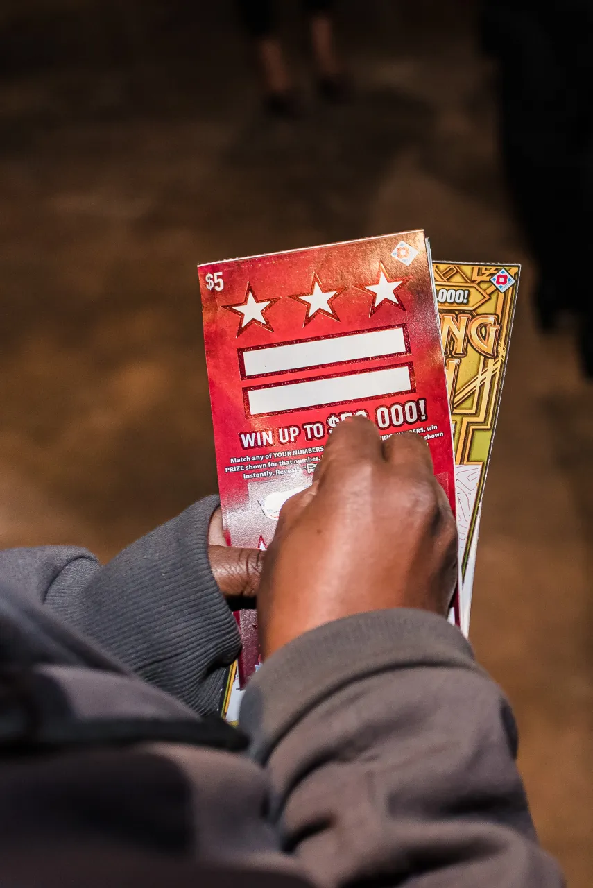 Man scratching tickets