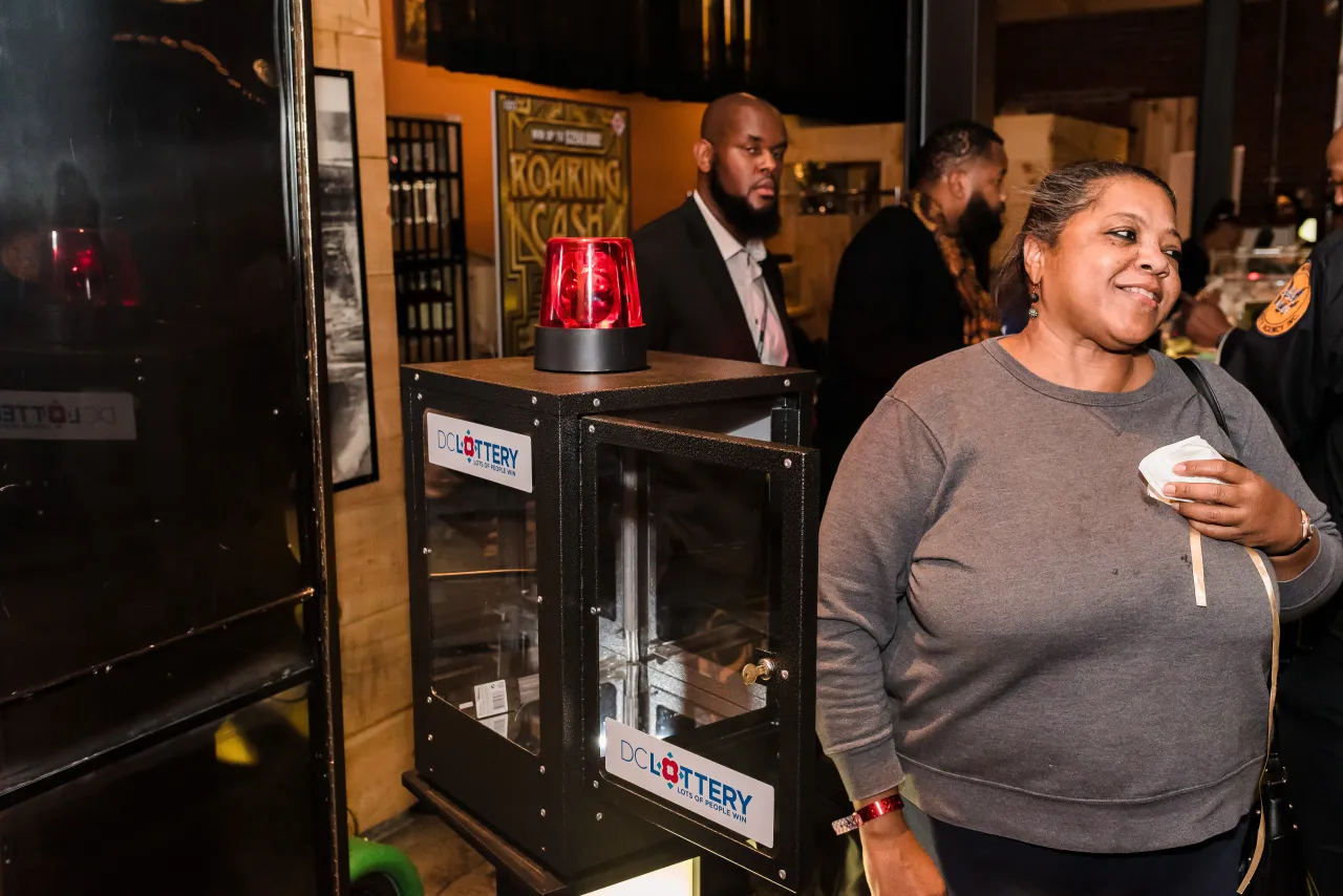 Woman opening DC Lottery Cash Vault game